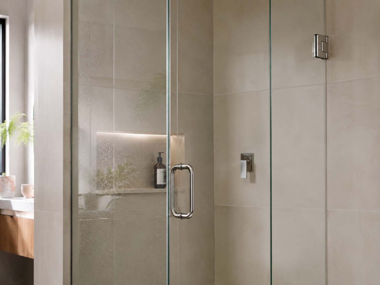 Close-up of an easy-clean frameless shower screen with clear glass and minimal hardware
