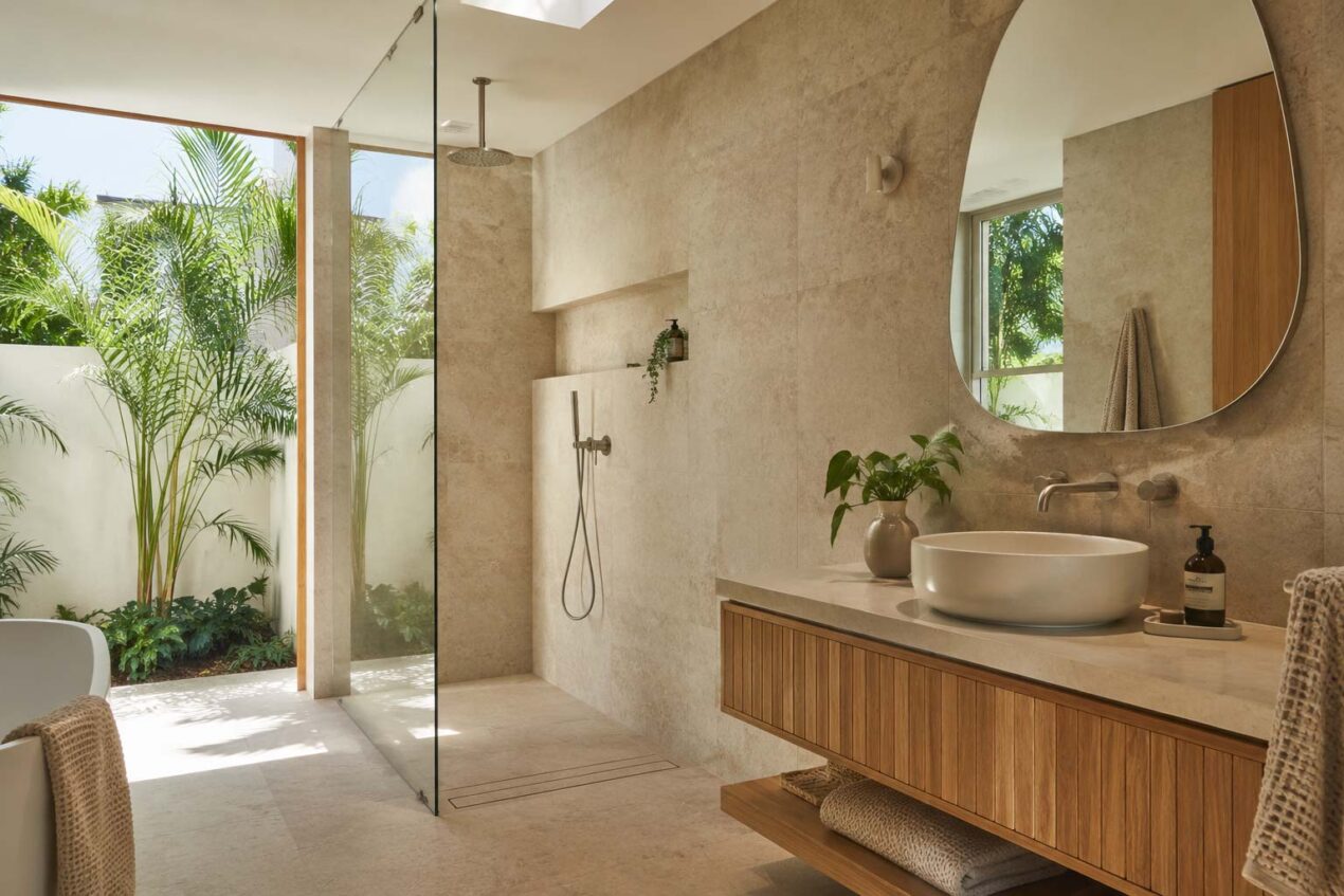 Contemporary Australian spa bathroom with frameless glass, warm neutral tiles and natural timber cabinetry