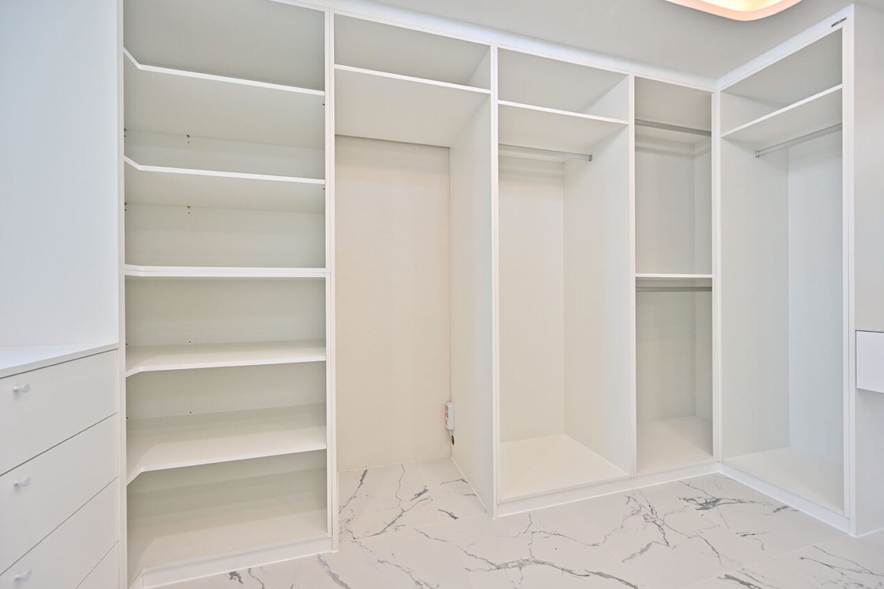 Walk-in wardrobe with empty shelving and modern storage solutions