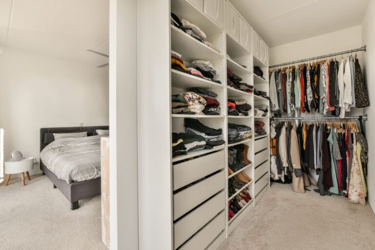 Spacious walk-in wardrobe layout with open shelves and ample hanging space in a modern bedroom
