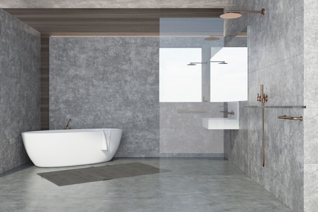 Fixed shower glass panel and freestanding bath in a contemporary grey bathroom