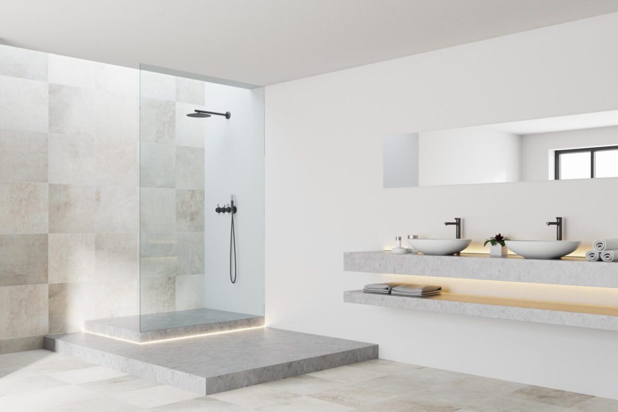 Fixed shower glass panel on raised step in light modern bathroom