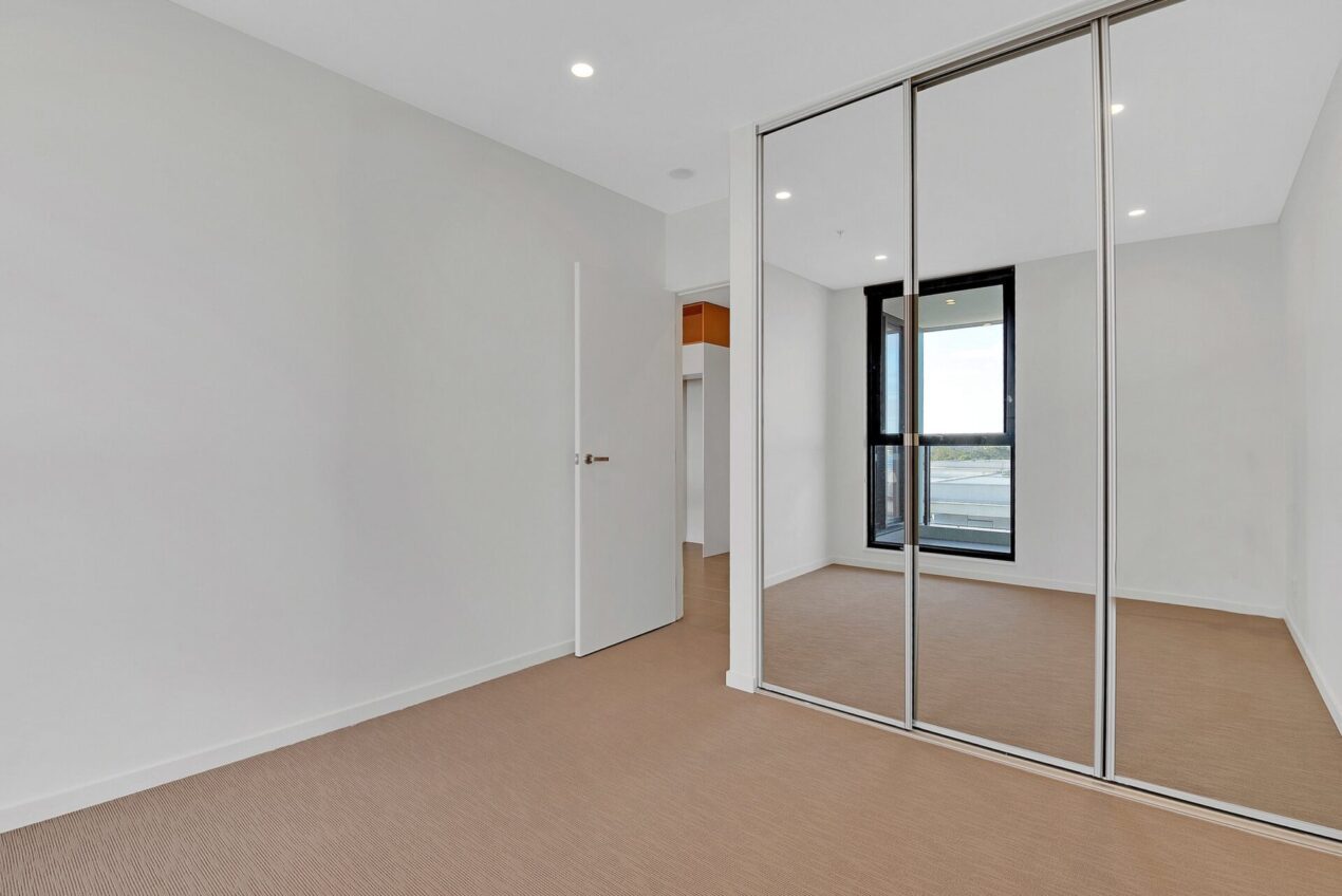 Sliding mirror wardrobe doors for bedroom with natural light