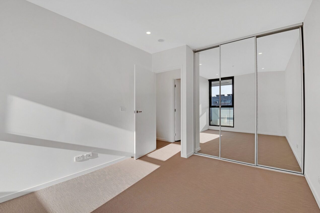 Bedroom with framed sliding wardrobe doors and mirrored panels