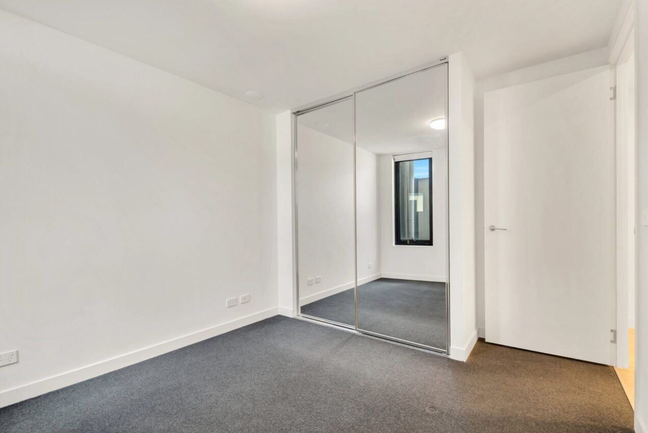 framed sliding wardrobe doors in empty bedroom