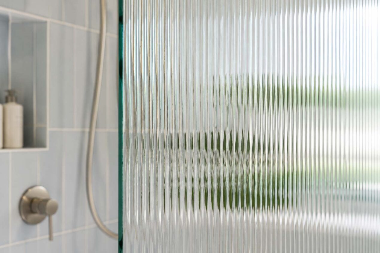 Fluted glass shower screen privacy showing reeded glass texture and soft light diffusion