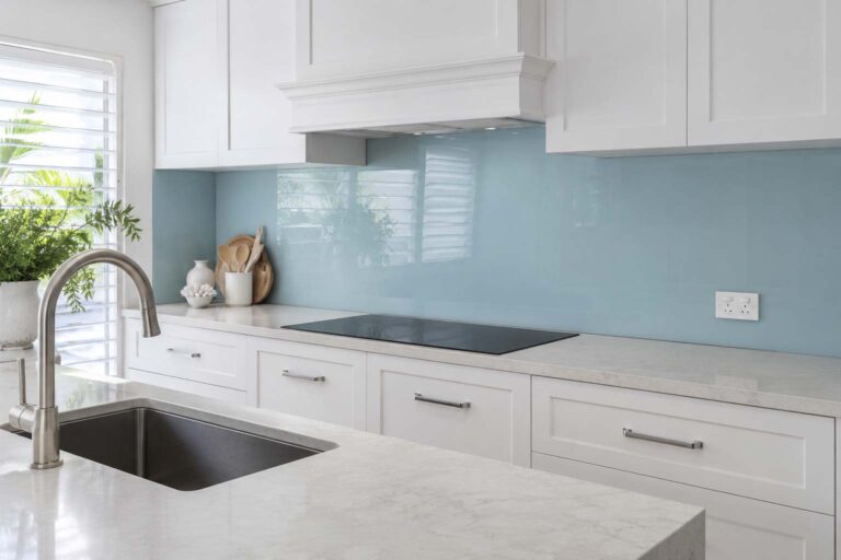 Kitchen splashback ideas Gold Coast article showing a coastal blue glass splashback in a Hamptons kitchen