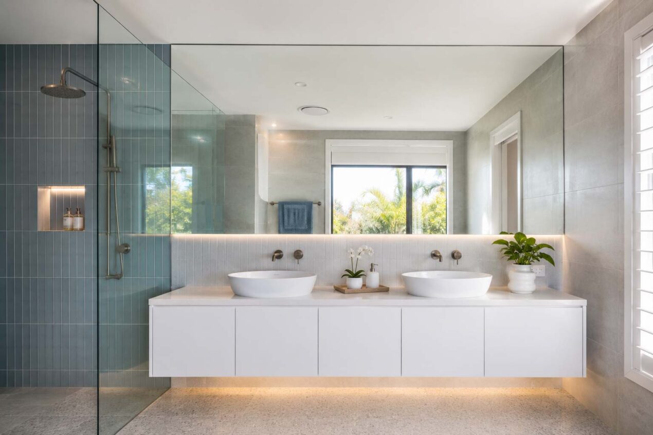Custom full-wall bathroom mirror above a vanity in a compact Gold Coast ensuite