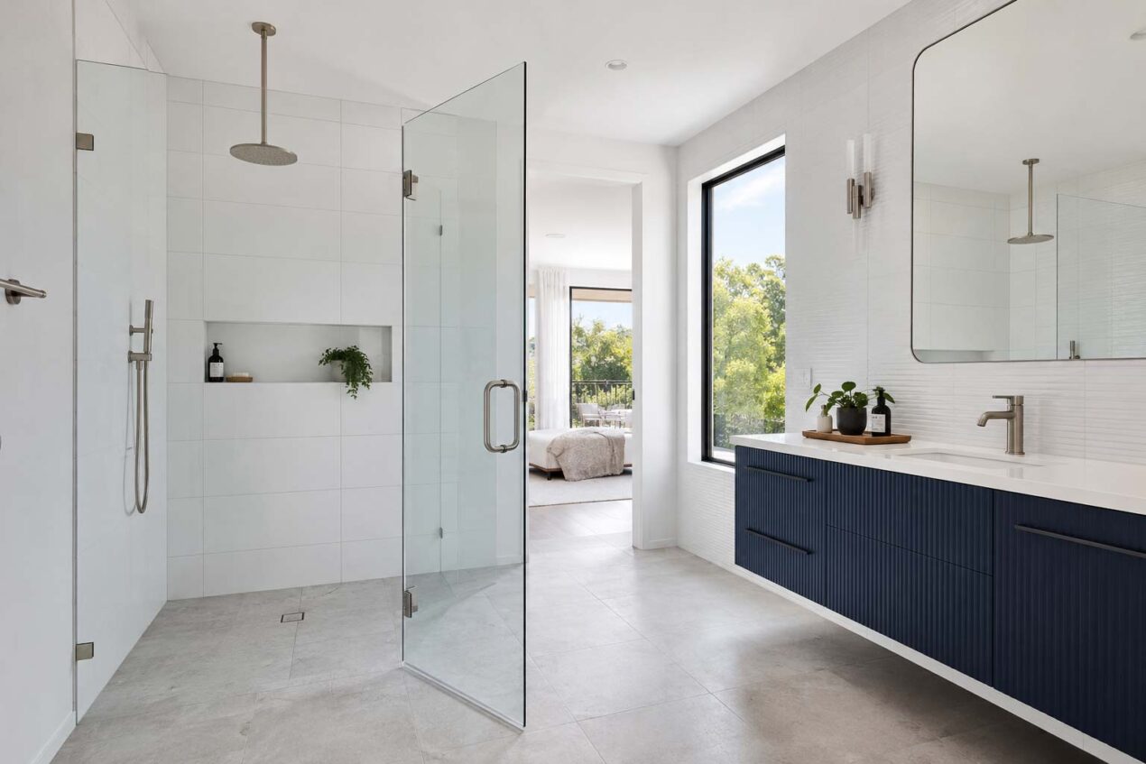 Frameless hinged shower screen with wide entry in a Gold Coast ensuite